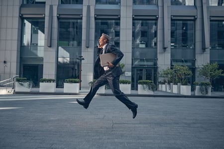 man-talking-on-phone-and-running-fast