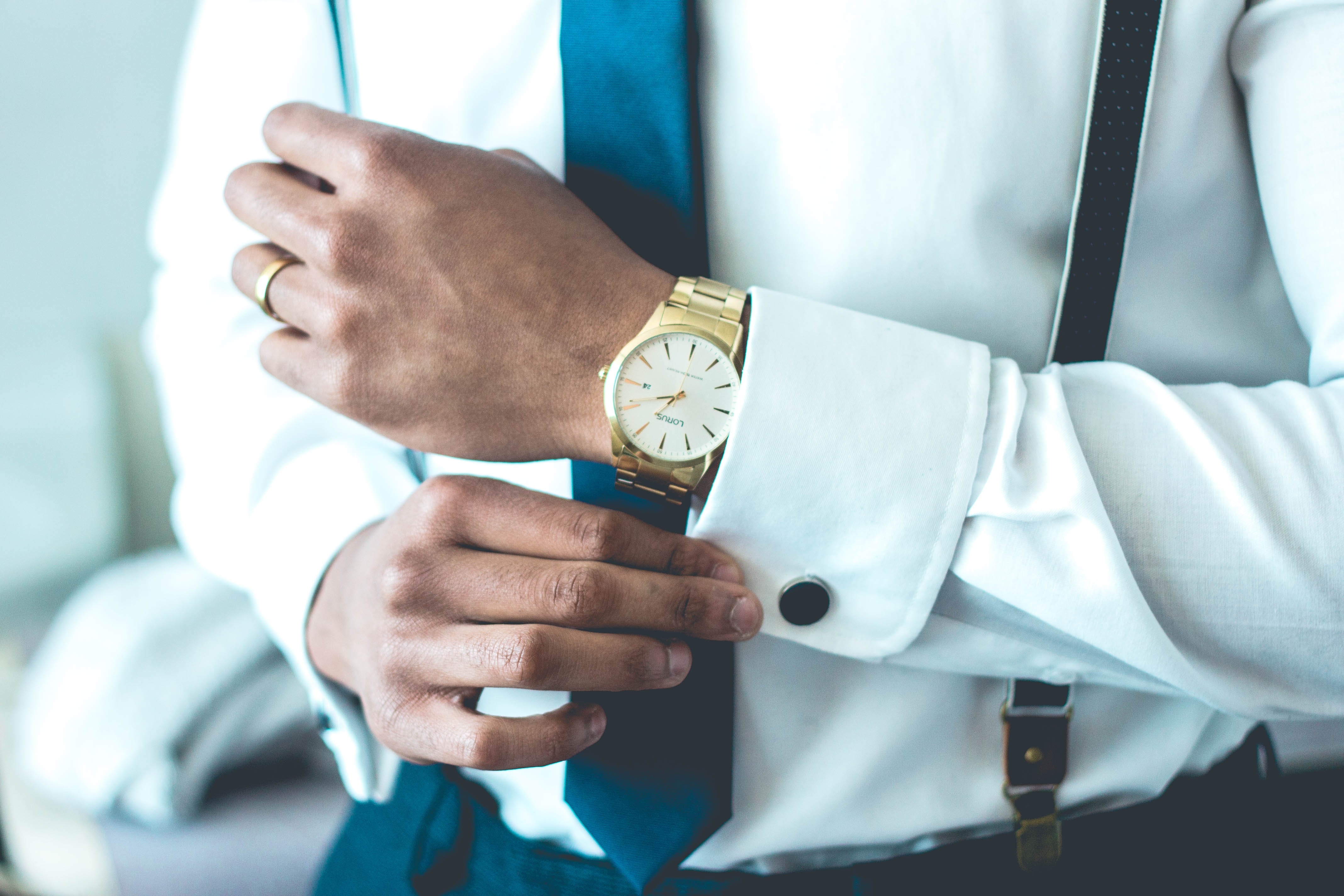 man with gold watch dressed up