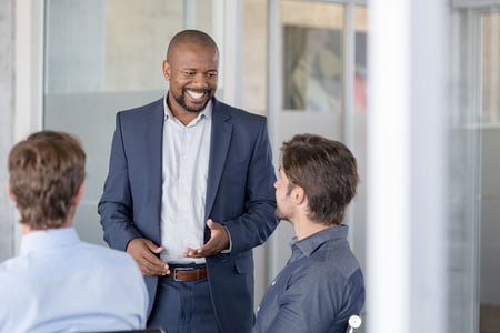 mature-business-man-in-meeting-smiling