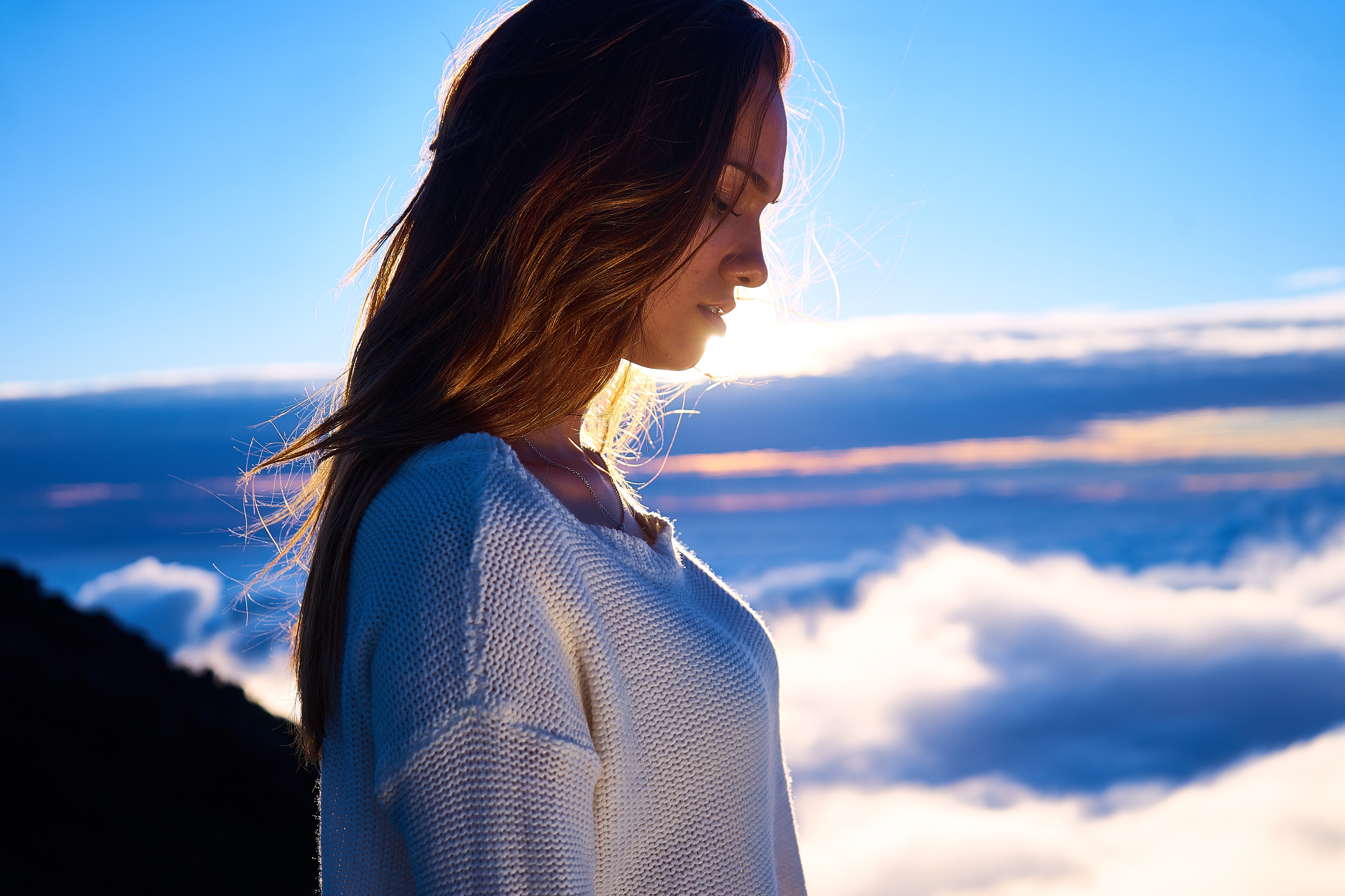 woman high up a mountain, looking down