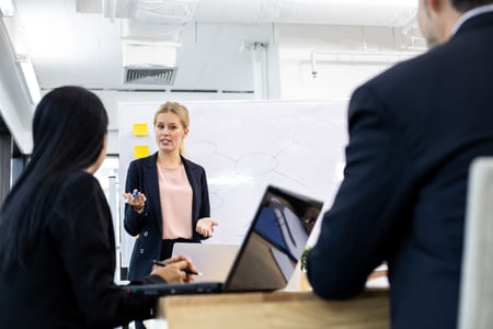 woman-offering-information-on-board-to-team