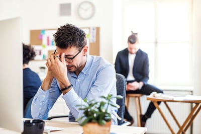 young-frustrated-businessman-with-smartphone-working