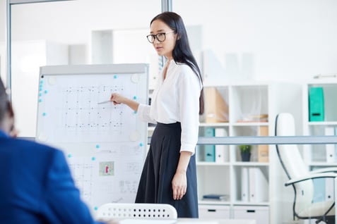 young-woman-giving-presentation-in-meeting